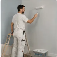 A decorator rolling paint onto a wall