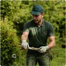 A gardener trimming planting in a garden