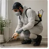 A pest controller treating a property in protective kit