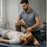 A physiotherapist treating a patient on a couch