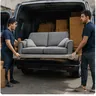 A removals team loading a van